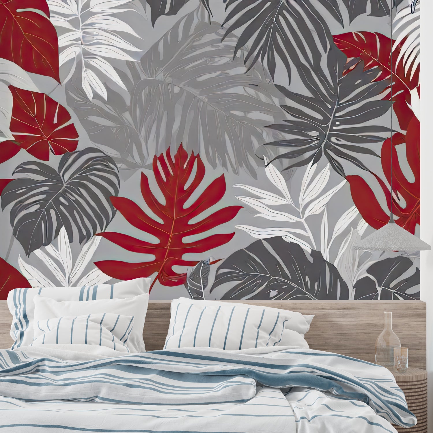 Red and grey Monstera leaf wallpaper in modern living room with grey sofa and natural light