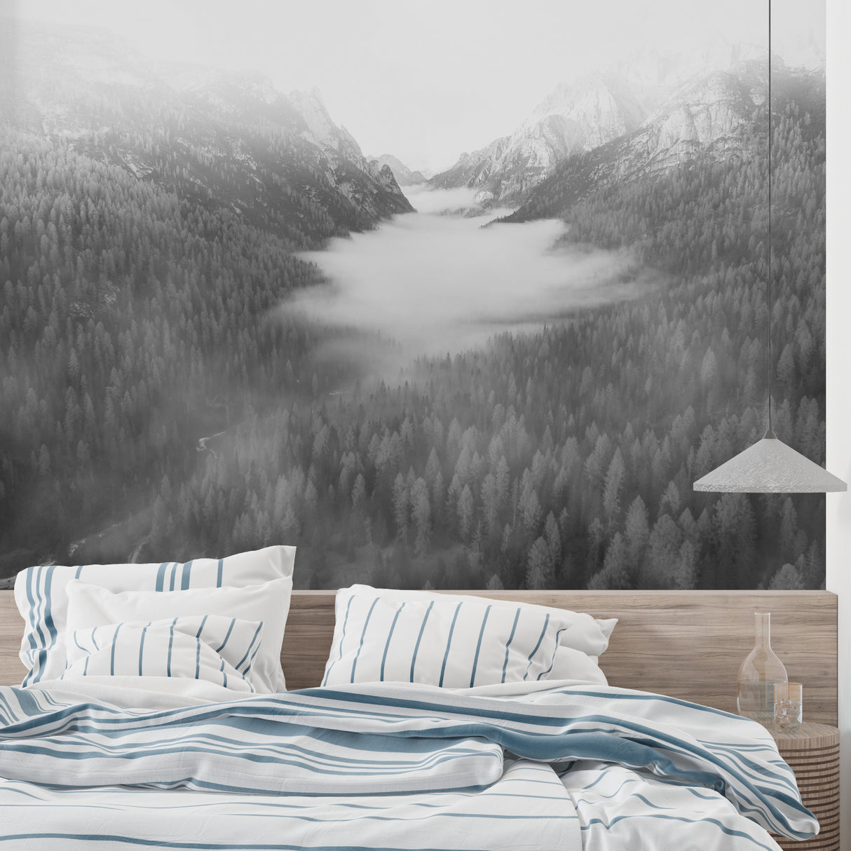 Mountain landscape wallpaper creating depth in modern living room with grey sofa and natural light