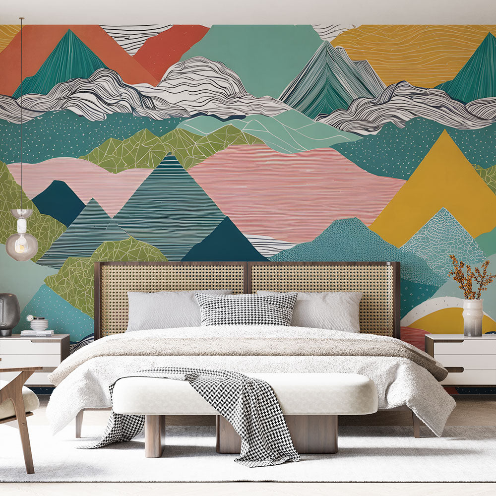 Modern mountain wallpaper mural in a bright contemporary living room, showing geometric abstract peaks in coral and teal