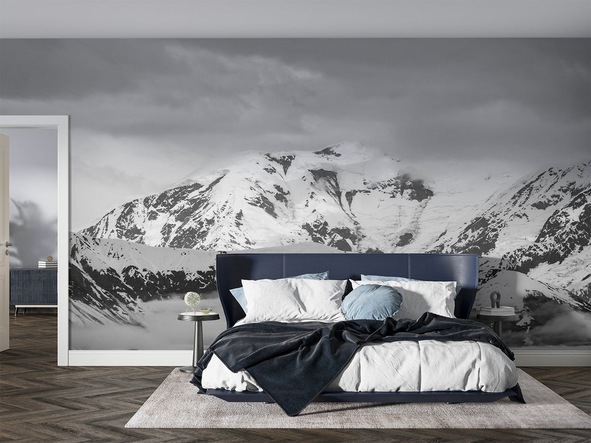 Mountain wall mural creating depth in modern living room with grey sofa and natural light
