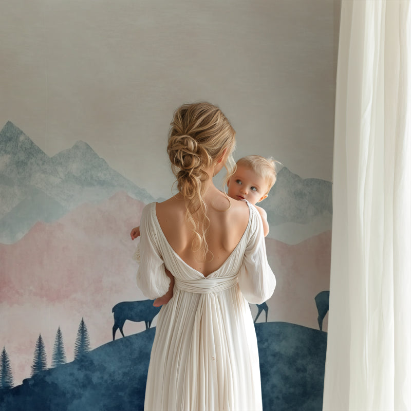 Mountain landscape wallpaper with deer silhouettes creating a peaceful atmosphere in a modern nursery