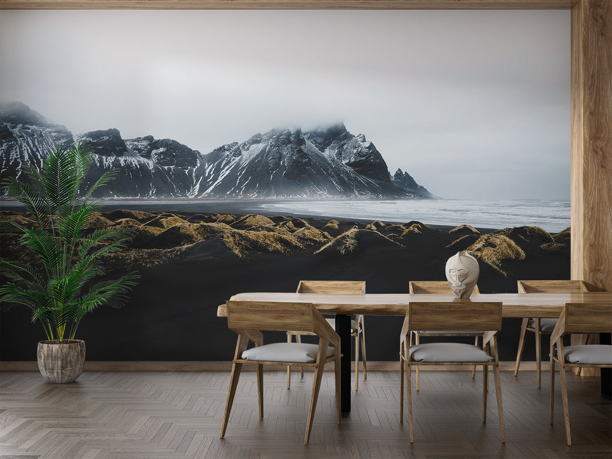 Mountain landscape wallpaper creating depth in modern living room with grey sofa and natural light
