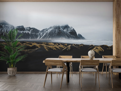 Mountain landscape wallpaper creating depth in modern living room with grey sofa and natural light