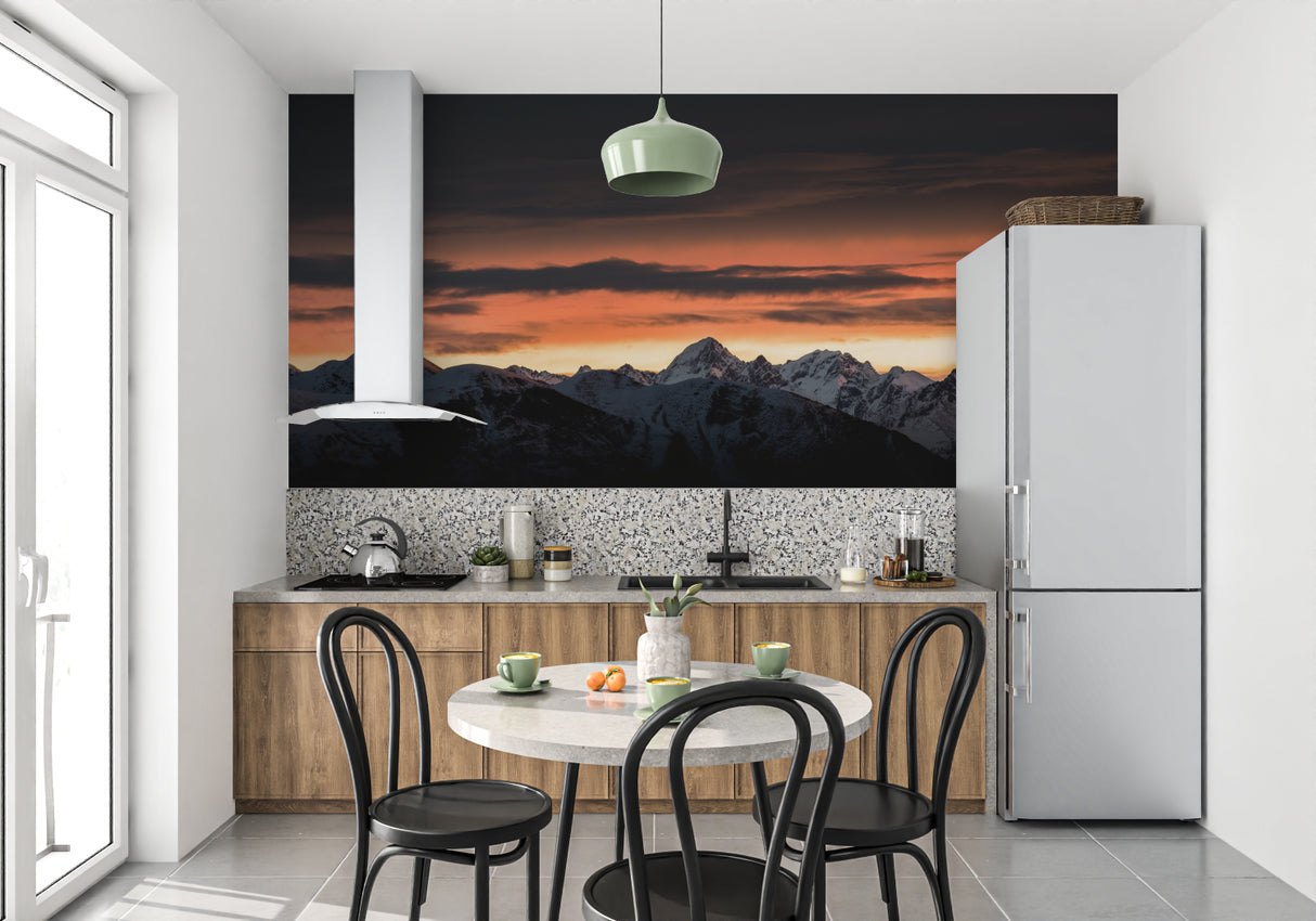 Hotel lobby showcasing large mountain wall mural with golden sunset glow