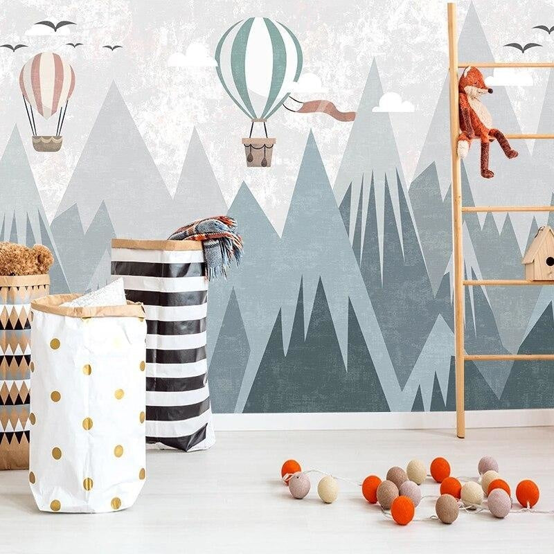 Adventure theme mountain wallpaper creating a cozy reading nook in a kid's bedroom