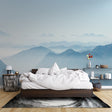 Mountain mural wallpaper creating depth in modern living room with grey sofa and natural light