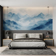 Mountain mural wallpaper creating depth in modern living room with blue accents