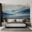 Mountain landscape wallpaper creating depth in modern living room with grey sofa