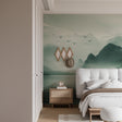 Mountain lake wallpaper in modern living room, showing reflective water and flying birds against misty peaks