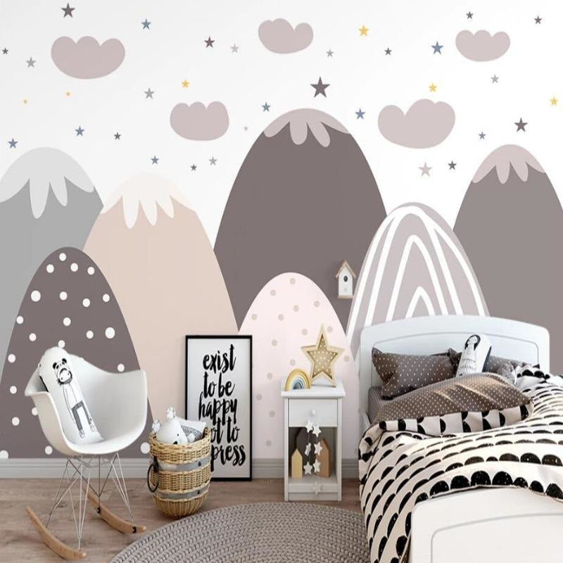 Mountain nursery wallpaper with stars creating a cozy atmosphere in a modern Scandinavian kids bedroom with white furniture