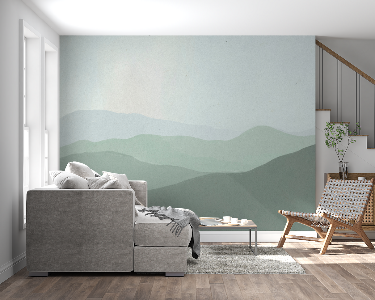 Mountain landscape wallpaper creating depth in modern living room with grey sofa and natural light