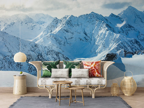 Mountain peak wallpaper creating depth in modern living room with grey sofa
