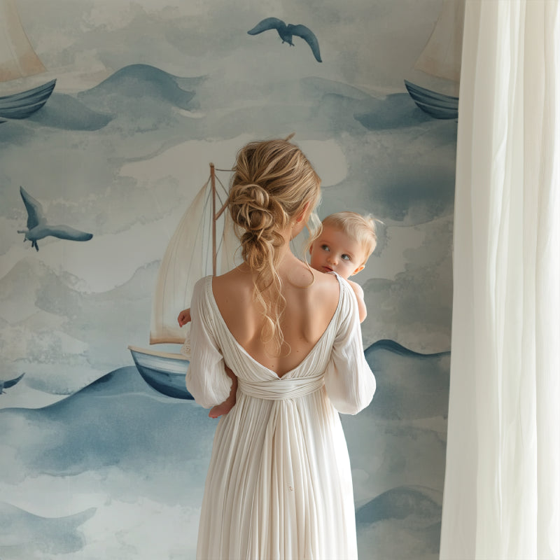 Seaside wall mural featuring gentle waves and sailboats in a cozy nursery setting