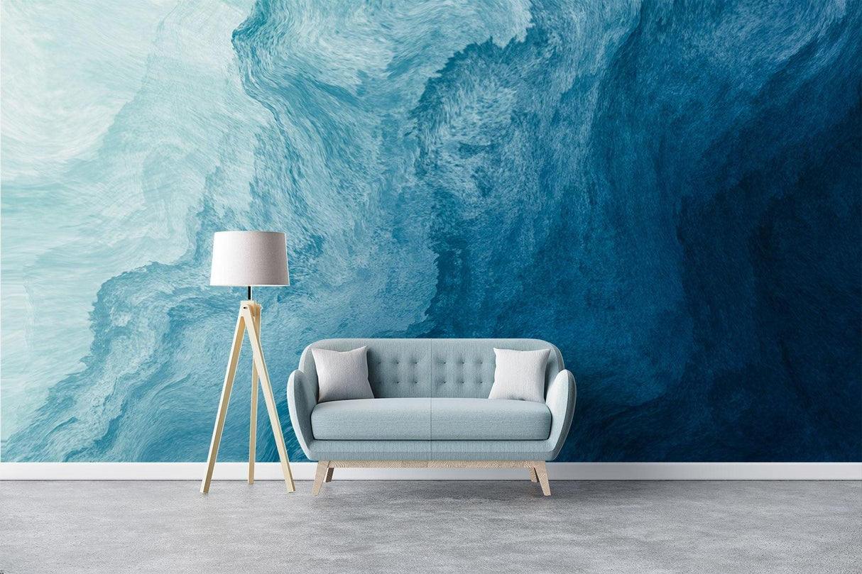 Ocean wave wallpaper creating a calm atmosphere in a modern living room with white furniture
