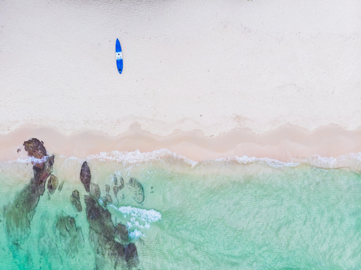 Aerial beach design file showing turquoise waters meeting sandy shores with surfboard accent