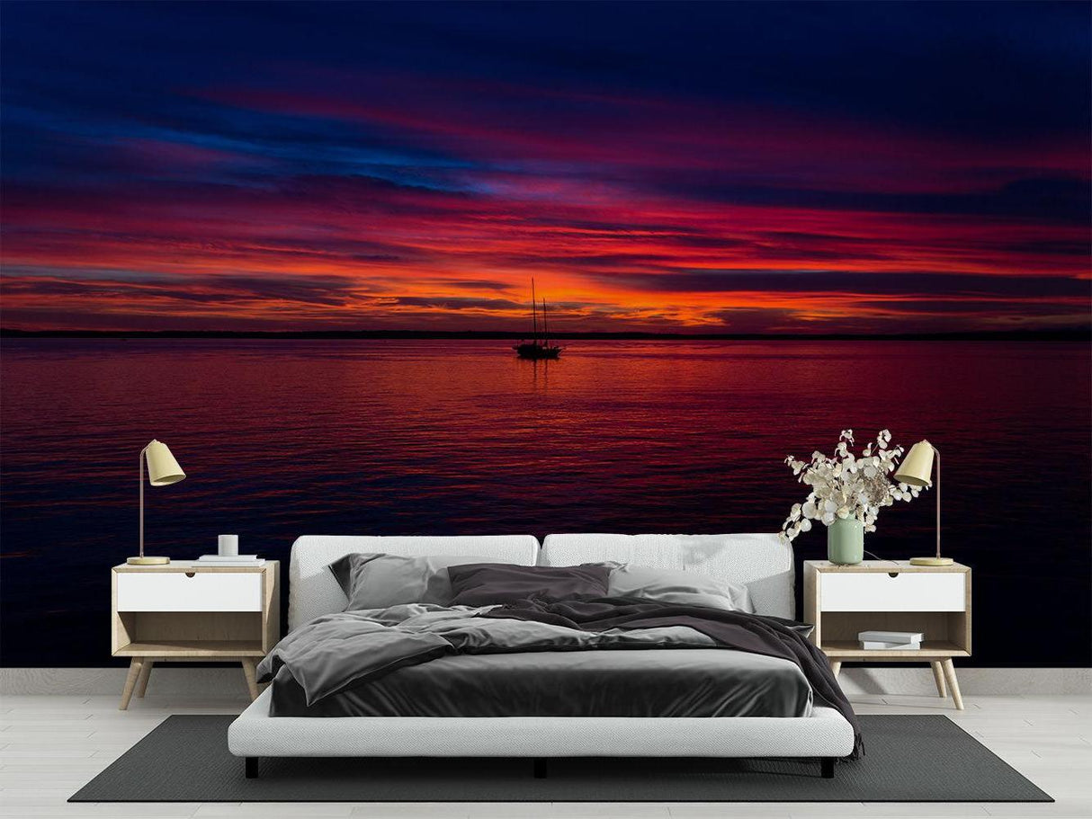 Ocean sunset mural wallpaper creating a cozy atmosphere in a modern living room with floor-to-ceiling windows