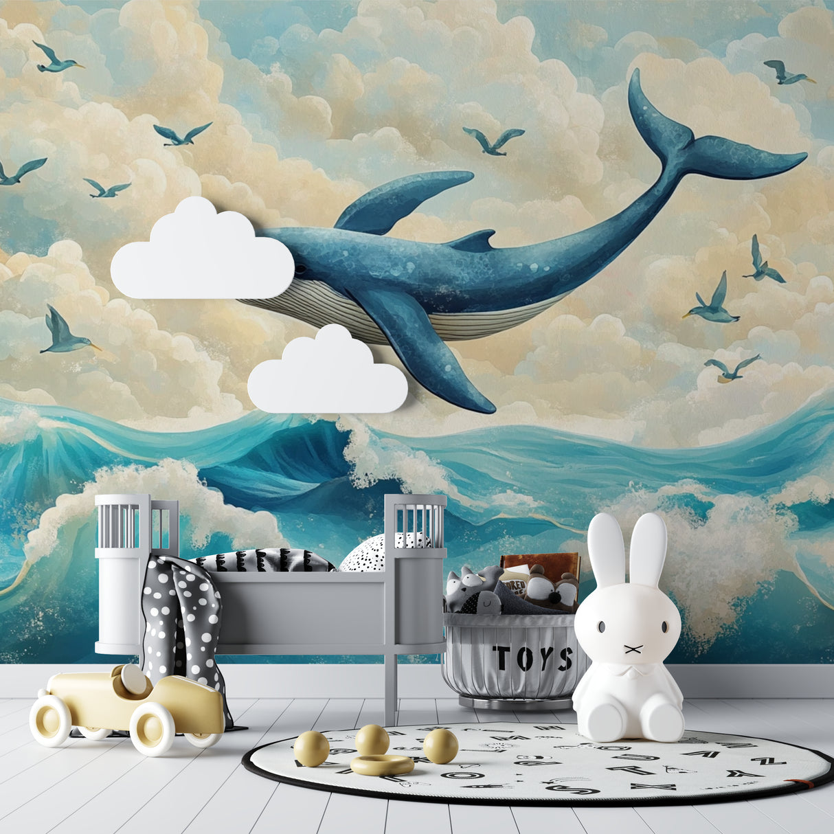 Ocean whale wallpaper mural styled in a bright modern nursery with white furniture