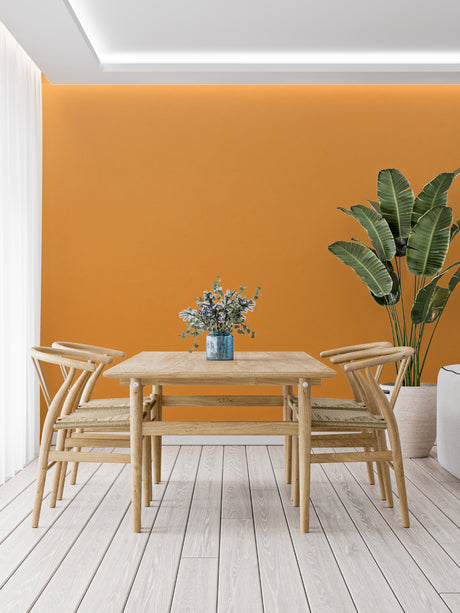 Orange wall mural in modern living room creating warm, inviting atmosphere with minimal furniture