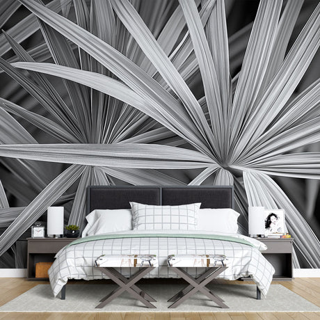 Black and white palm leaf wallpaper creating dramatic contrast in a modern living room with minimalist furniture