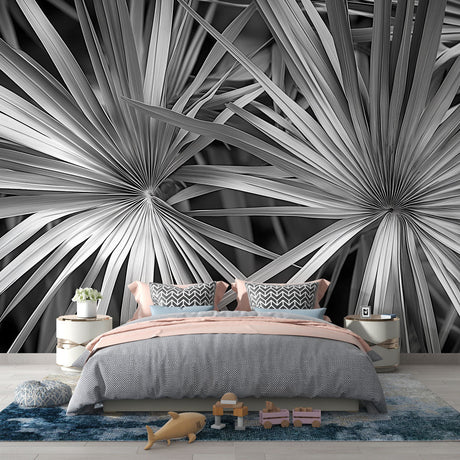 Black and white palm leaf wallpaper creating dramatic contrast in a modern living room with minimal furniture