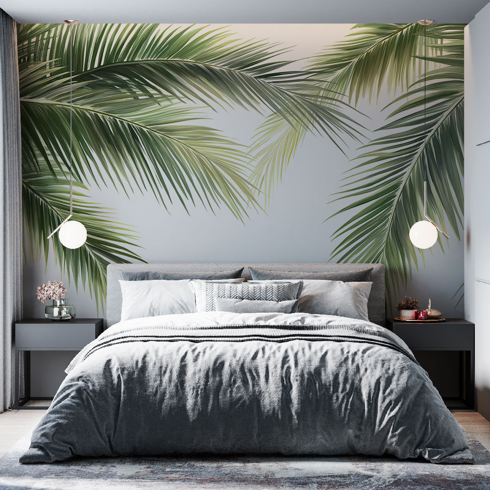 Tropical palm leaves wallpaper creating a fresh green accent wall in a modern white living room with natural light