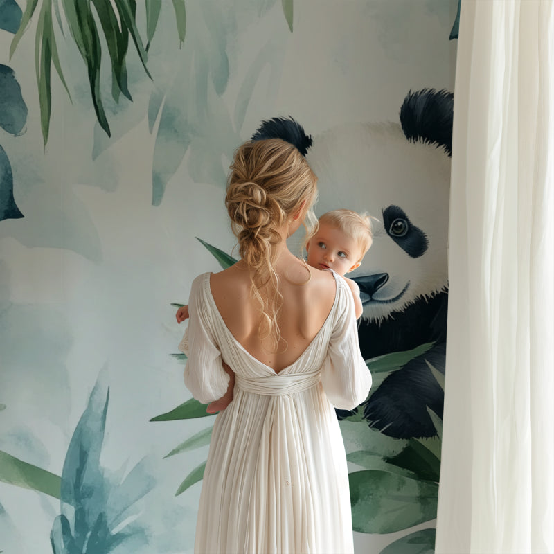 Panda wallpaper mural in bright nursery with white furniture showing watercolor tropical design