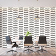 Modern wave pattern wallpaper creating movement in a minimal living room with white sofa and black accents