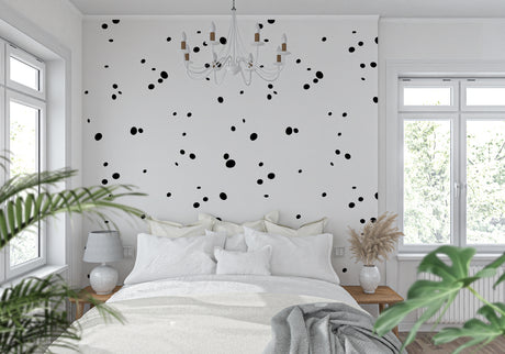 Modern black polka dot wallpaper in a bright living room creating a playful yet sophisticated atmosphere