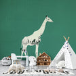 Modern Safari Wallpaper with white giraffe silhouette styled in a bright Scandinavian living room setting