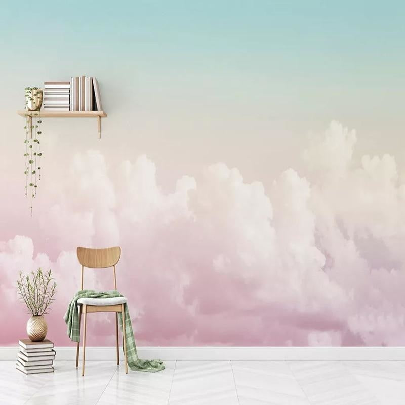 Pink cloud wallpaper creating a dreamy atmosphere in a modern nursery with white furniture