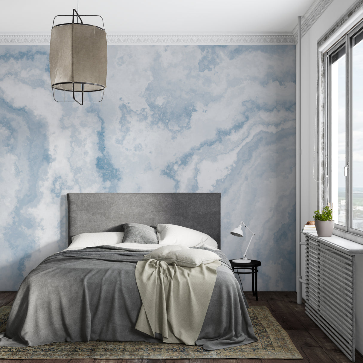 Cloud mural wallpaper creating a serene atmosphere in a modern living room with natural light