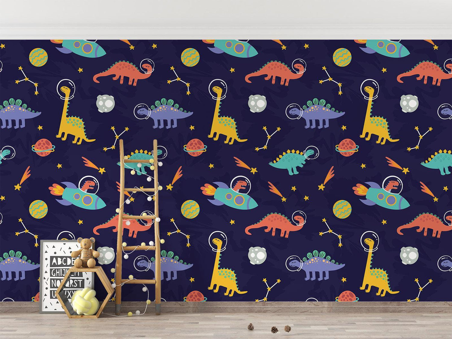Kids reading nook with the dinosaur space wallpaper, showing how it creates a cozy story corner