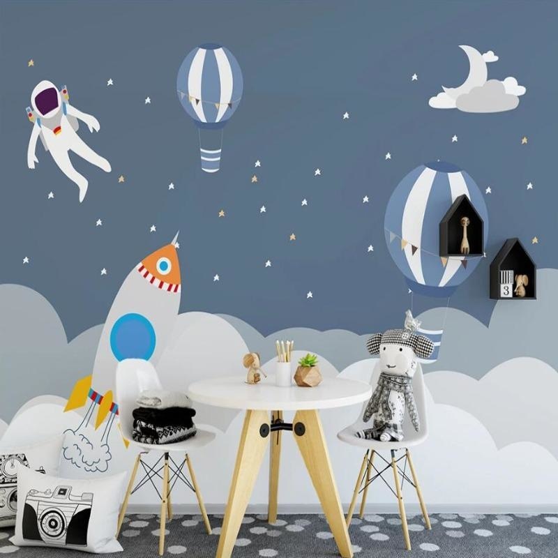 Playroom featuring space adventure wallpaper with astronaut and balloons in natural daylight