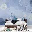 Space theme wallpaper creating a magical atmosphere in a cozy nursery with soft lighting