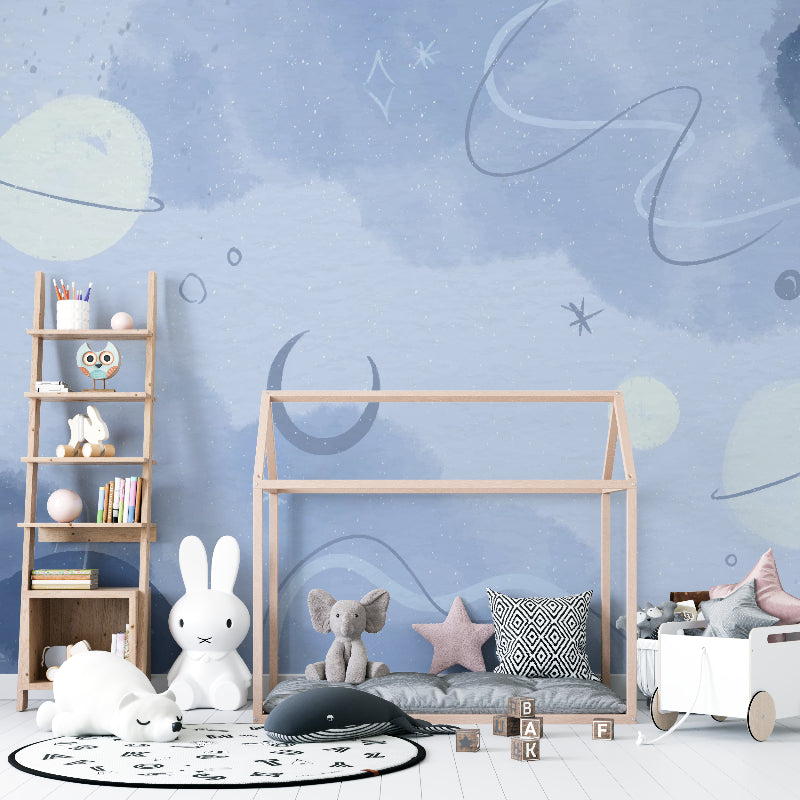 Space mural wallpaper adding cosmic charm to a reading nook with gentle star patterns