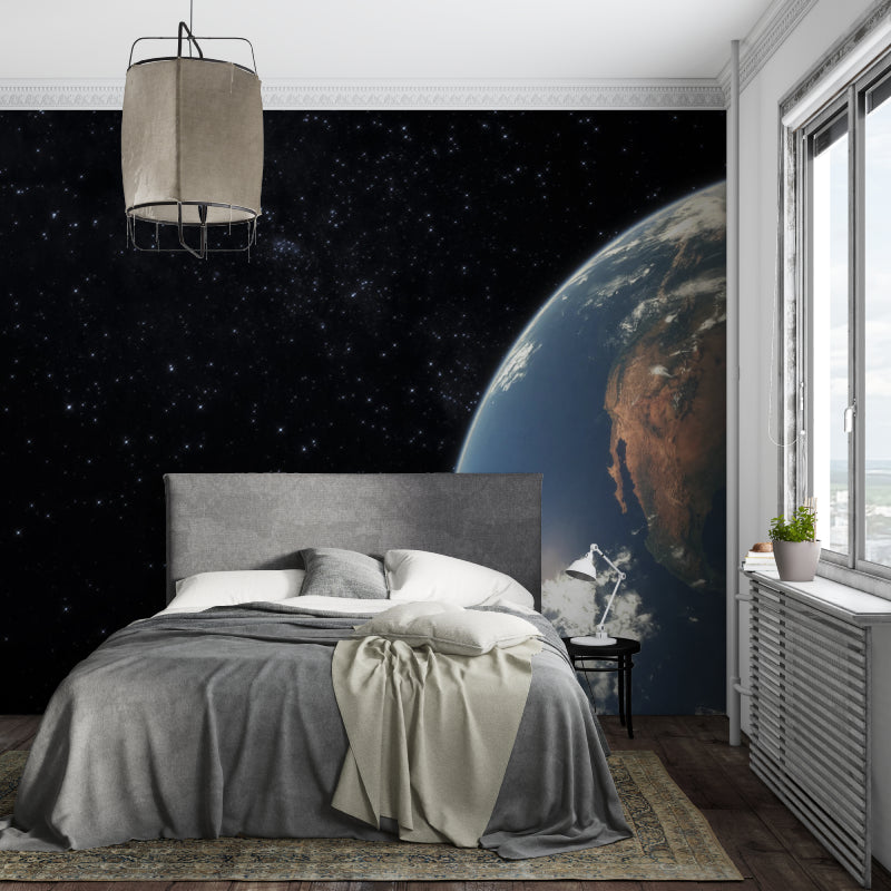 Planet Earth mural wallpaper in kid's bedroom with space-themed decorations