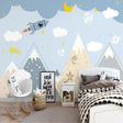 Space adventure wallpaper creating a dreamy atmosphere in a modern nursery with soft lighting and wooden furniture