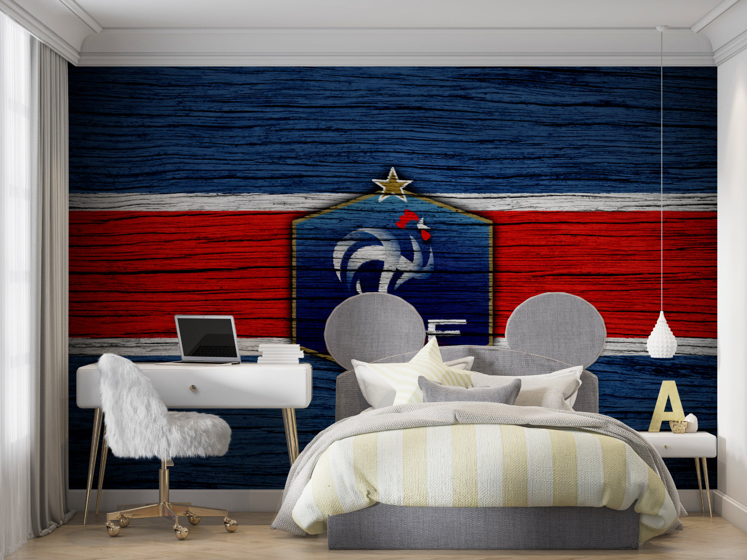 Sports themed wall mural in teen bedroom with gaming setup and football accessories