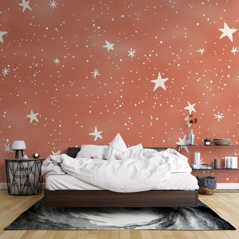 Terracotta star wallpaper in a cozy bedroom creating a warm, dreamy atmosphere