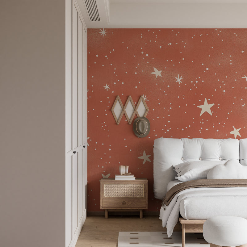 Celestial wallpaper adorning a nursery wall with soft terracotta tones