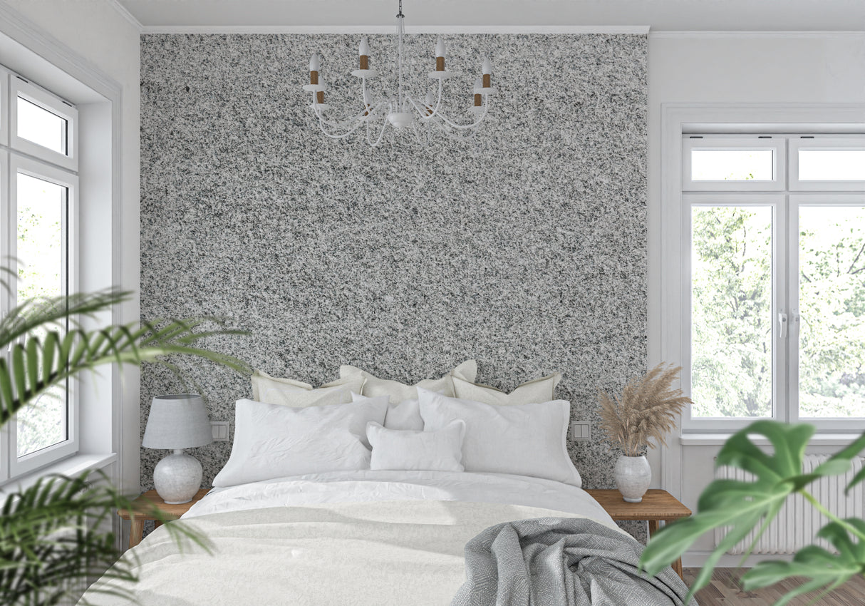 Grey speckled stone wallpaper in dining room with natural lighting