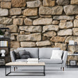 Stone wall mural in a modern living room showing natural limestone texture with warm lighting creating depth and dimension