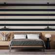 Modern navy blue striped wallpaper in a bright home office, creating a professional and clean backdrop for remote work