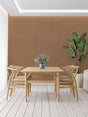 Terracotta wall mural creating a warm atmosphere in a modern living room with minimal furniture