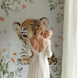 Tiger cub nursery wallpaper in a cozy pink nursery with white furniture and soft lighting