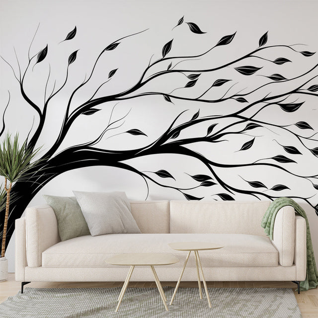 Black and white tree wallpaper creating depth in a modern minimalist living room with natural light streaming through windows
