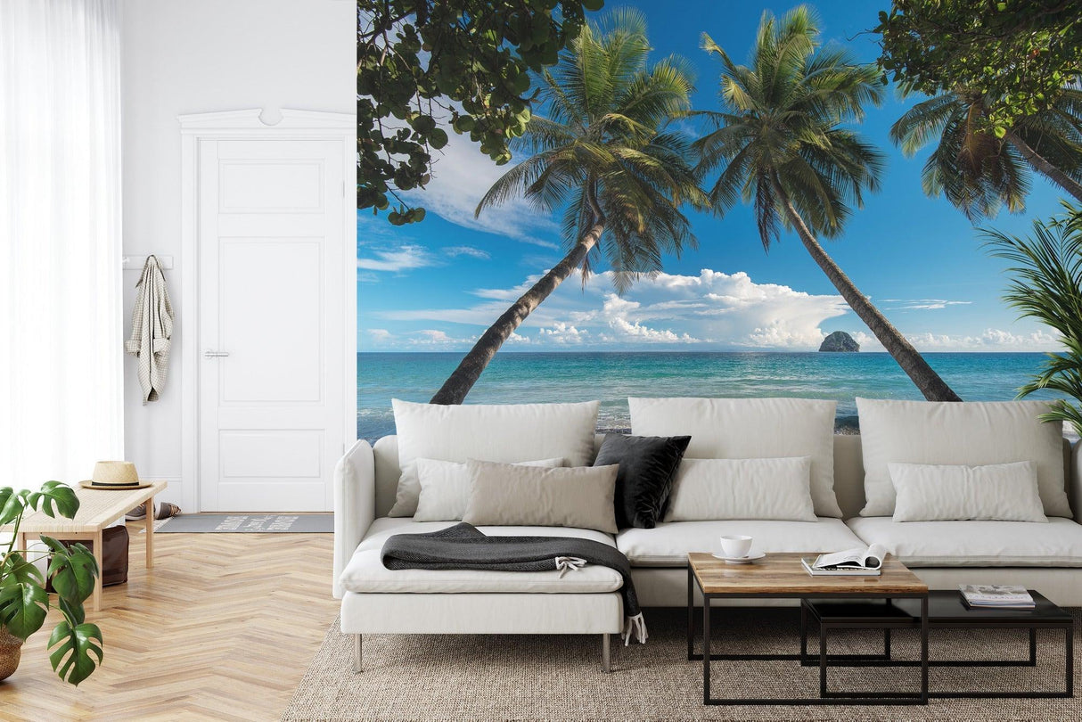 Beach scene mural wallpaper in master bedroom showing palm trees and ocean view