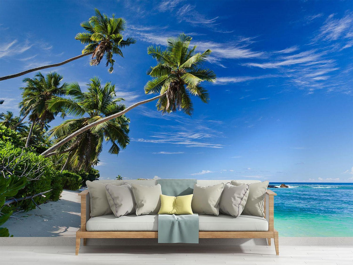 Tropical beach wallpaper creating a relaxing atmosphere in a modern living room with white furniture