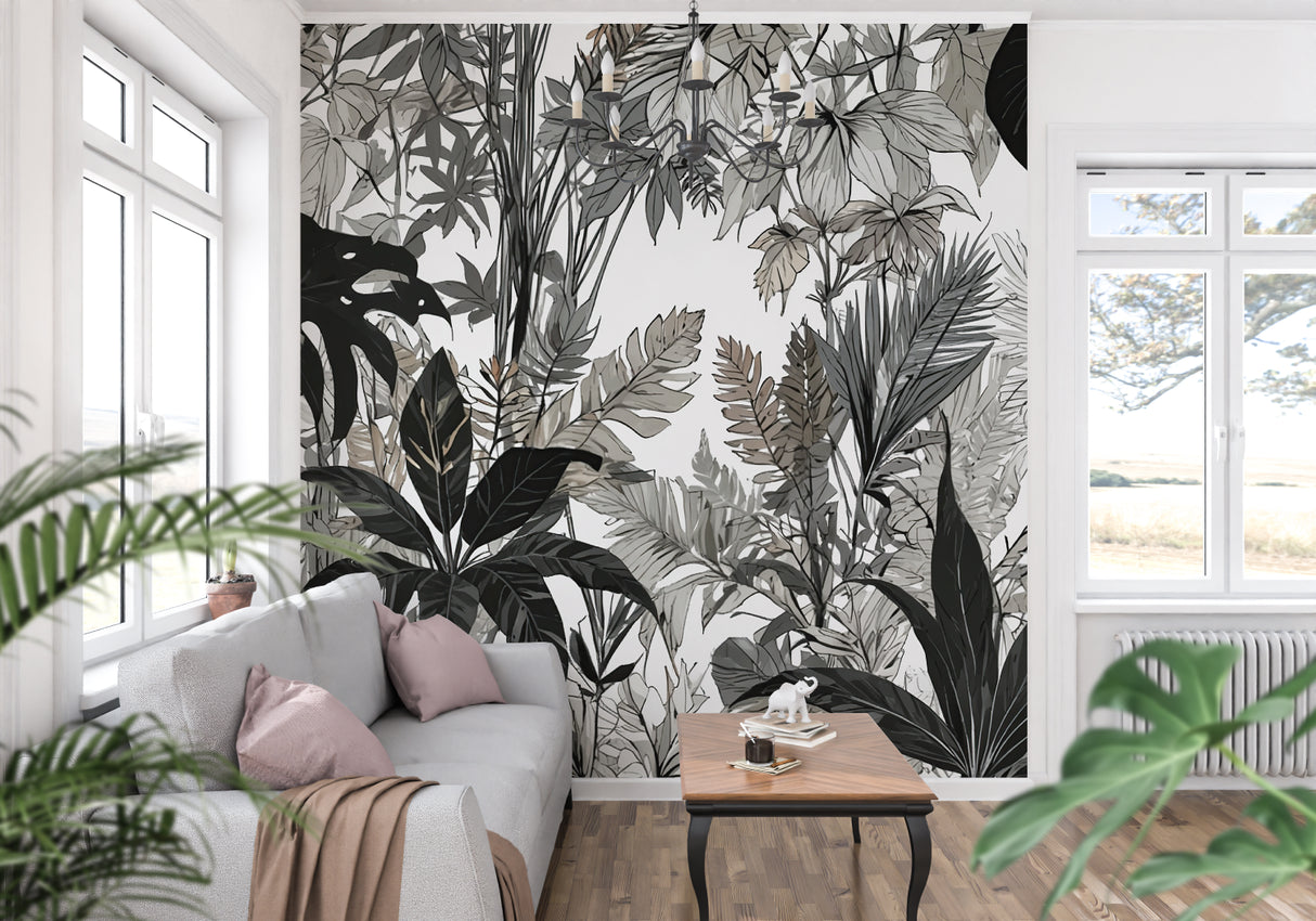 Black and white tropical wallpaper creating drama in a modern living room with white sofa and minimal decor