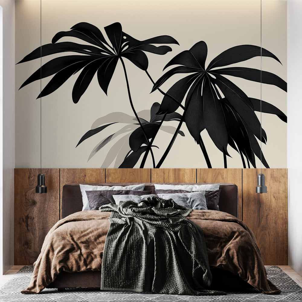 Modern living room with black palm leaves wallpaper mural creating a bold tropical statement wall behind gray sofa